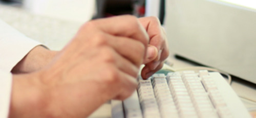 Hände tippen auf einer Computertastatur